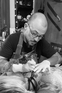 Tattoo Artist At Work On A Back Piece